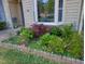 Manicured front yard with colorful flowers, lush greenery, and bay window at 35 Stonewall Way, Durham, NC 27704
