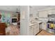 Open kitchen with stone countertops and stainless steel appliances overlooking living space at 35 Stonewall Way, Durham, NC 27704