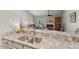 Kitchen with stainless steel sink and granite countertops opens to the living area with fireplace at 35 Stonewall Way, Durham, NC 27704