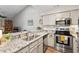 Well-equipped kitchen featuring stone countertops and stainless steel appliances at 35 Stonewall Way, Durham, NC 27704