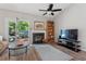 Living room includes a fireplace, wooden bookshelf, and a sliding glass door leading to a patio at 35 Stonewall Way, Durham, NC 27704