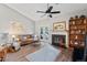 Spacious living room with fireplace, ceiling fan, and sliding glass doors that lead to patio at 35 Stonewall Way, Durham, NC 27704