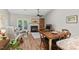 Open concept living and dining area with fireplace and access to outdoor patio at 35 Stonewall Way, Durham, NC 27704
