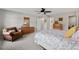 Spacious main bedroom featuring neutral walls, ceiling fan, sitting area, and ensuite bathroom at 35 Stonewall Way, Durham, NC 27704