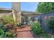 Cozy patio area with brick paving, surrounded by lush greenery and a privacy fence at 35 Stonewall Way, Durham, NC 27704