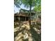 Expansive backyard view featuring a multi-level deck, lush landscaping, and mature trees at 3504 Rock Creek Dr, Raleigh, NC 27609