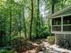 Well maintained backyard with a deck, lush landscaping, and mature trees at 3504 Rock Creek Dr, Raleigh, NC 27609