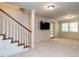 Spacious basement rec room featuring a staircase and walkout to the backyard at 3504 Rock Creek Dr, Raleigh, NC 27609