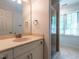 Bathroom with tile floors, double vanity, and glass shower enclosure at 3504 Rock Creek Dr, Raleigh, NC 27609