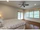 Spacious bedroom with hardwood floors, bright windows, and a ceiling fan at 3504 Rock Creek Dr, Raleigh, NC 27609