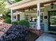 Inviting front porch with swing, rocking chair, and stylish brick accents at 3504 Rock Creek Dr, Raleigh, NC 27609