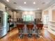 Stylish kitchen with a breakfast bar, stainless appliances, and hardwood floors at 3504 Rock Creek Dr, Raleigh, NC 27609