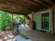 Inviting covered brick patio with an outdoor seating area and access to the backyard at 3504 Rock Creek Dr, Raleigh, NC 27609