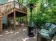Outdoor brick patio with a heater and comfortable seating for entertaining guests at 3504 Rock Creek Dr, Raleigh, NC 27609