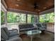 Inviting screened porch with wicker furniture and a clear view of the surrounding greenery at 3504 Rock Creek Dr, Raleigh, NC 27609