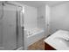 Well-lit bathroom featuring a glass-enclosed shower, separate soaking tub, and double vanity at 351 Gilman Ln # 109, Raleigh, NC 27610