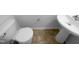 Bathroom featuring a toilet and pedestal sink with neutral flooring in a bright, neutral-toned room at 351 Gilman Ln # 109, Raleigh, NC 27610