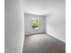 Bedroom featuring neutral carpeting, white walls, and a bright window overlooking the greenery at 351 Gilman Ln # 109, Raleigh, NC 27610