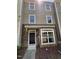 Charming townhome featuring a stone facade and well-maintained landscaping at 351 Gilman Ln # 109, Raleigh, NC 27610