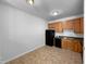 Efficient kitchen featuring black appliances and light wood cabinets at 351 Gilman Ln # 109, Raleigh, NC 27610