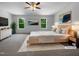 Bright main bedroom features plush carpet, ceiling fan, and abundant natural light from two windows at 351 Gilman Ln # 109, Raleigh, NC 27610
