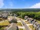 Scenic aerial view of a neighborhood showcasing craftsman-style homes near a lush green forest at 403 Prestwood Dr, Hillsborough, NC 27278