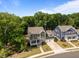 Aerial view of the green and blue homes showcases the neighborhood's curb appeal at 403 Prestwood Dr, Hillsborough, NC 27278