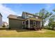 View of the backyard, highlighting the deck, screened porch, and spacious lawn at 403 Prestwood Dr, Hillsborough, NC 27278