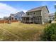 Spacious backyard featuring lush green grass, a patio, and a well-maintained lawn at 403 Prestwood Dr, Hillsborough, NC 27278