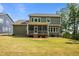 Well-maintained backyard with screened porch, lush lawn, and mature trees creating a private oasis at 403 Prestwood Dr, Hillsborough, NC 27278