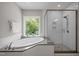 Elegant bathroom featuring a soaking tub with window views and separate glass shower at 403 Prestwood Dr, Hillsborough, NC 27278