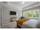 Bright bedroom with a large window and a mounted flat screen television at 403 Prestwood Dr, Hillsborough, NC 27278