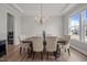 Elegant dining room with tray ceiling, chandelier, and large window for natural light at 403 Prestwood Dr, Hillsborough, NC 27278