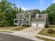 Charming two-story home featuring an attached two-car garage and a welcoming front porch at 403 Prestwood Dr, Hillsborough, NC 27278