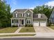 Traditional two-story home with a welcoming front porch and a convenient two-car garage at 403 Prestwood Dr, Hillsborough, NC 27278