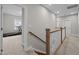 Bright hallway with a wooden staircase and view of the room with a treadmill at 403 Prestwood Dr, Hillsborough, NC 27278