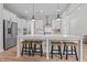 Spacious white kitchen island with bar seating, a sink, and pendant lighting above it at 403 Prestwood Dr, Hillsborough, NC 27278