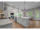Modern kitchen has white cabinets, subway tile backsplash, an island, and stainless-steel appliances at 403 Prestwood Dr, Hillsborough, NC 27278