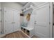 Functional mudroom with bench seating, storage baskets, hooks, and a shelving unit above at 403 Prestwood Dr, Hillsborough, NC 27278