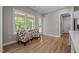 Bright sitting area featuring two chairs with leaf patterned fabric and large windows overlooking greenery at 403 Prestwood Dr, Hillsborough, NC 27278