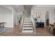 Elegant staircase with hardwood floors and natural light, creating a warm and inviting ambiance at 403 Prestwood Dr, Hillsborough, NC 27278