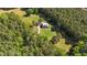 Aerial view of private home surrounded by dense, beautiful forest at 407 Howard Tant Rd, Zebulon, NC 27597
