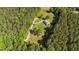 Aerial view of charming home surrounded by tall mature trees at 407 Howard Tant Rd, Zebulon, NC 27597