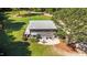 Aerial shot of home backyard, featuring patio with outdoor seating, lush green lawn, and natural landscaping at 407 Howard Tant Rd, Zebulon, NC 27597