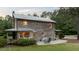 Back of a log cabin with a metal roof, patio, and outdoor seating at 407 Howard Tant Rd, Zebulon, NC 27597