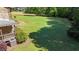 A beautifully landscaped backyard with a covered porch, garden, and well-maintained lawn at 407 Howard Tant Rd, Zebulon, NC 27597