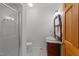 Bathroom featuring glass shower, patterned tile floor, and vintage-style vanity at 407 Howard Tant Rd, Zebulon, NC 27597