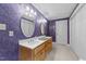 The bathroom features a double vanity, wallpaper, and ample storage space at 407 Howard Tant Rd, Zebulon, NC 27597