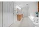 Bright bathroom featuring double sinks, a soaking tub, and plenty of cabinet space for storage at 407 Howard Tant Rd, Zebulon, NC 27597