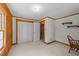 Wood paneled bedroom with white walls, double closet, wood trim, and a view into an adjacent room at 407 Howard Tant Rd, Zebulon, NC 27597
